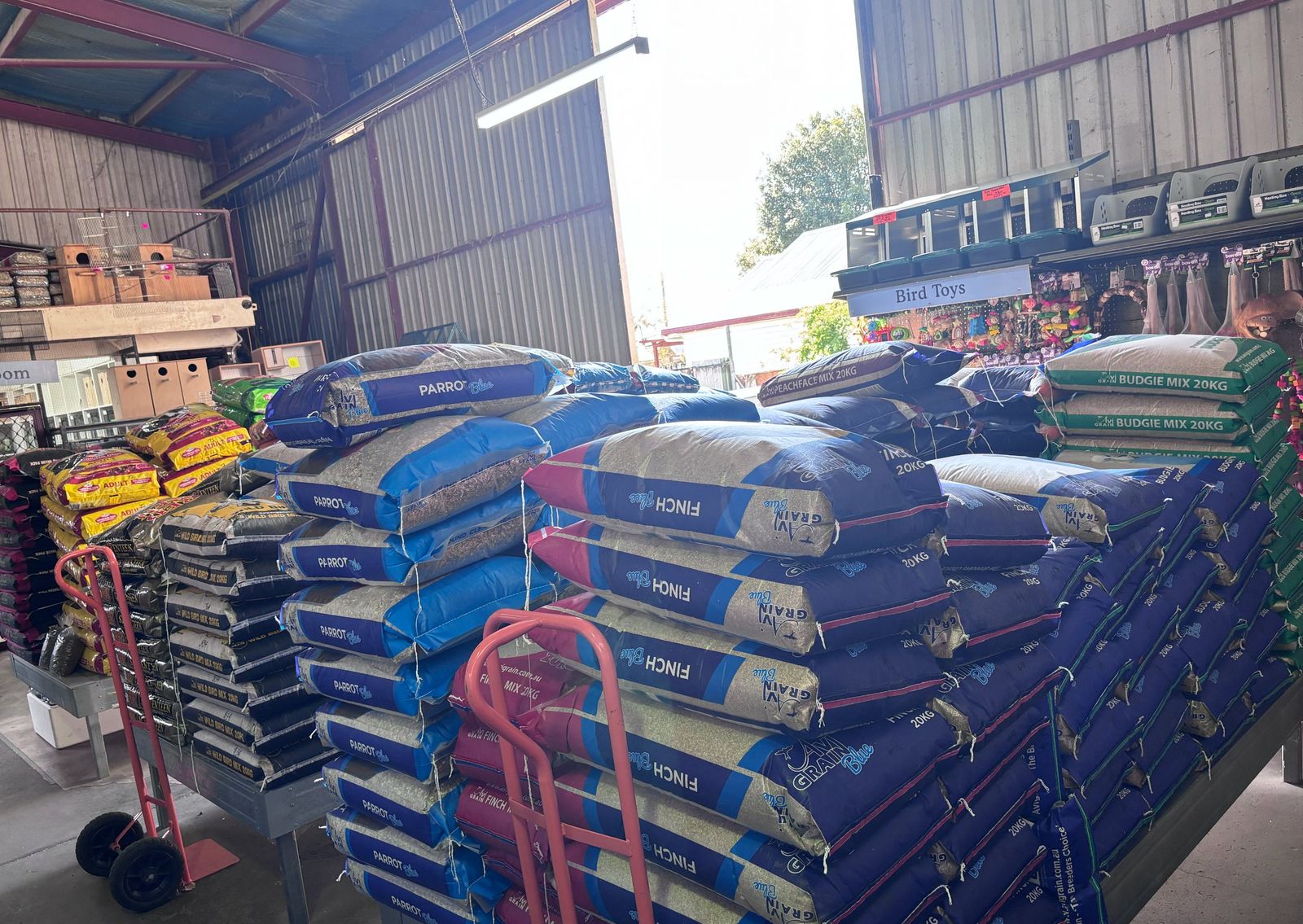 Bags of parrot, finch and budgie mix stacked in the shop